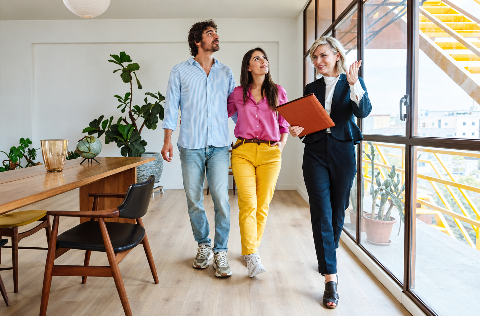 Home buyers touring a property with a real estate professional
